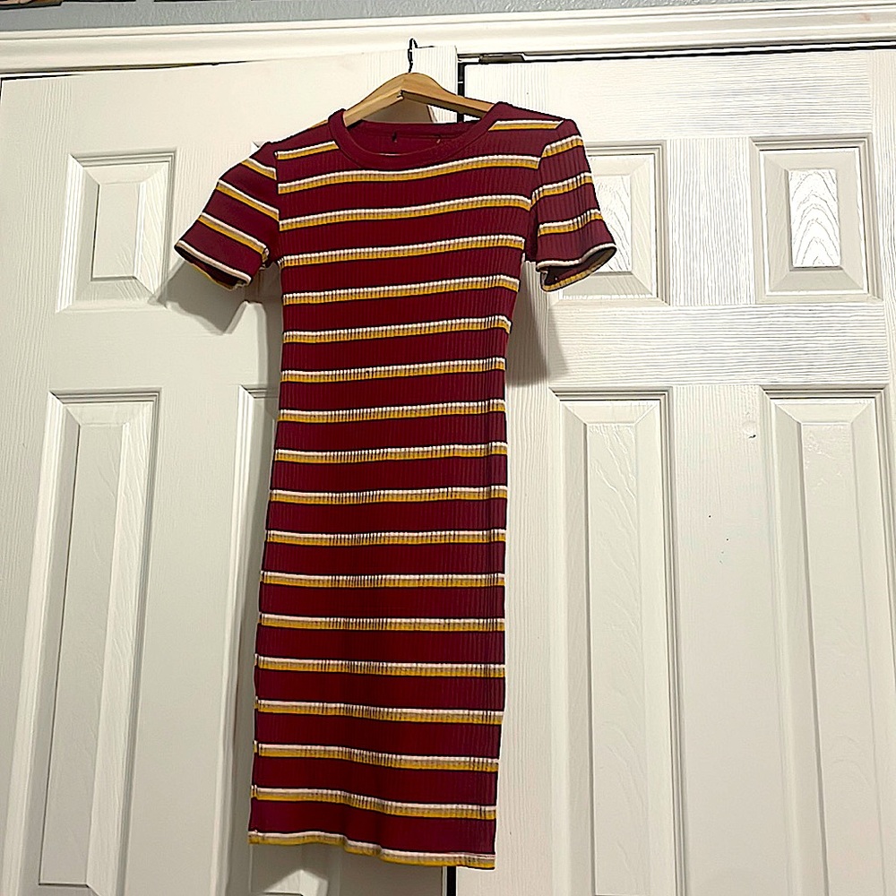 Red tight fitted dress with white tan and yellow stripes.